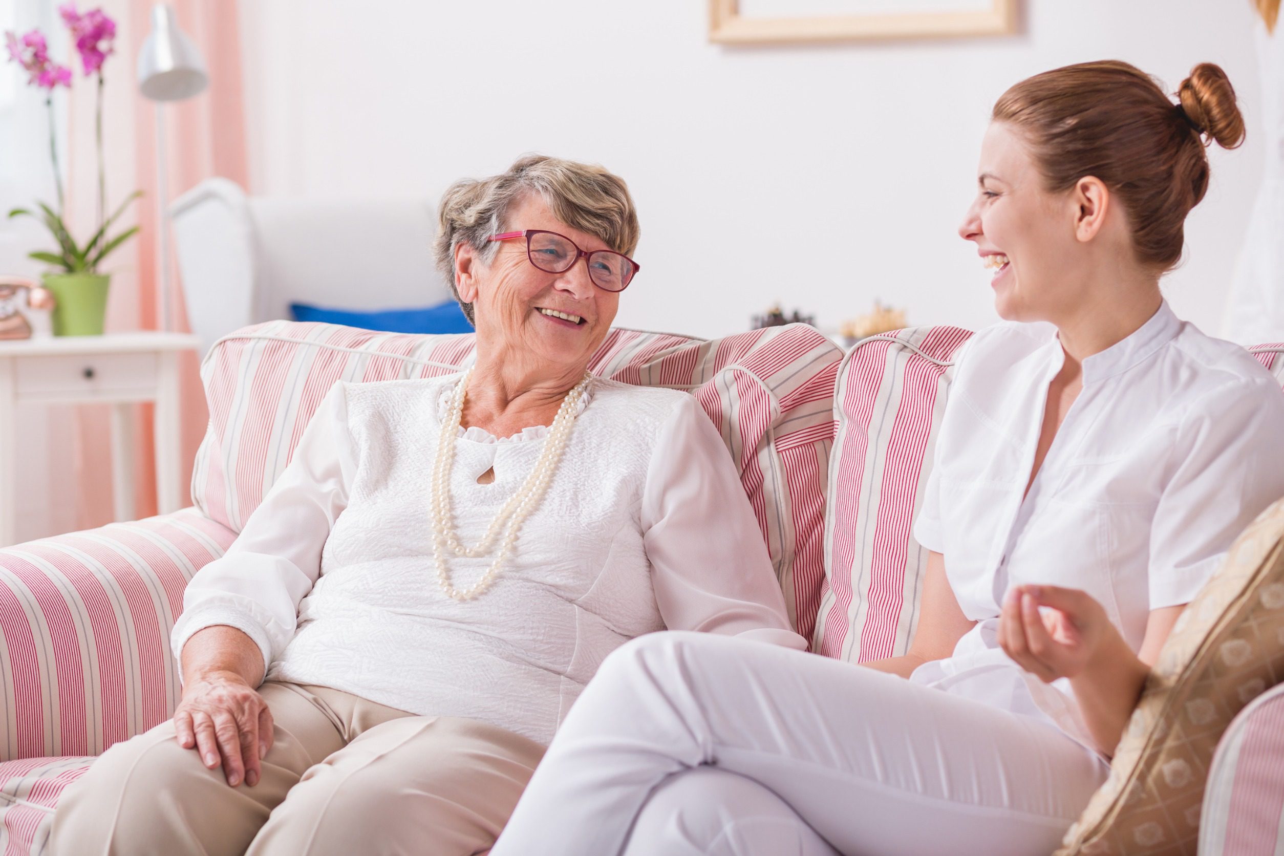 Conversation between senior woman and young smiled nurse